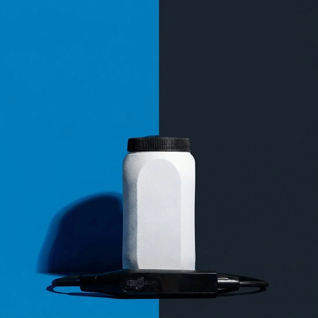 AquaRinse water tank on a two-tone blue background